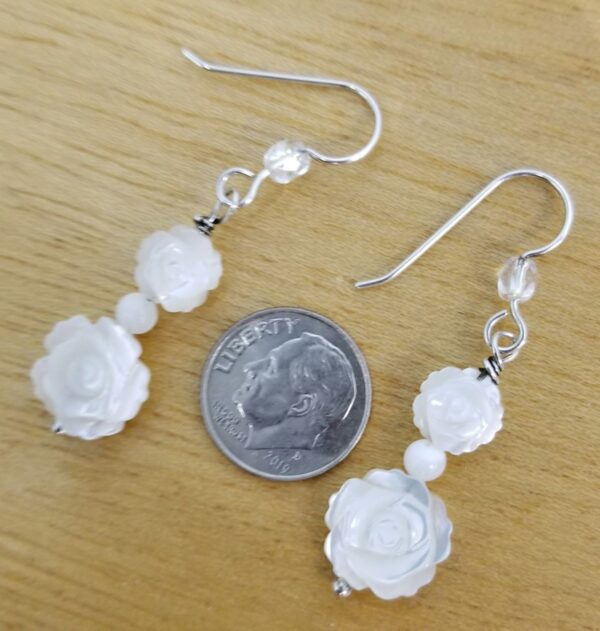 carved mother of pearl flower earrings with dime for scale