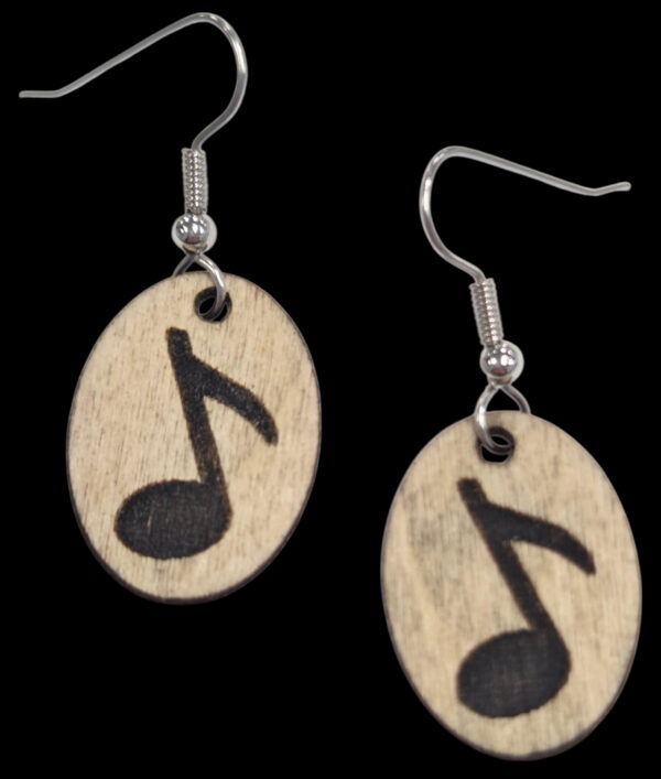 music note earrings on black background