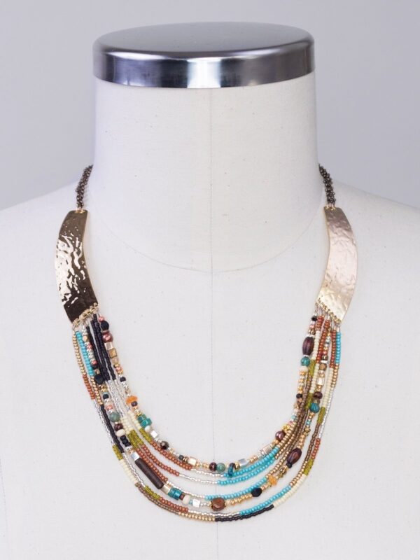 turquoise, red aventurine, wood, and Bohemian glass beaded necklace by Holly Yashi on dress form