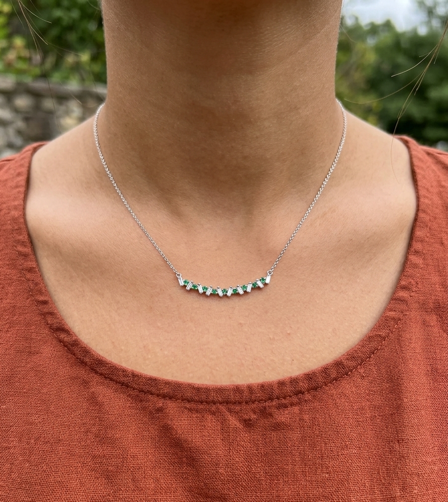 dainty emerald and diamond necklace on model