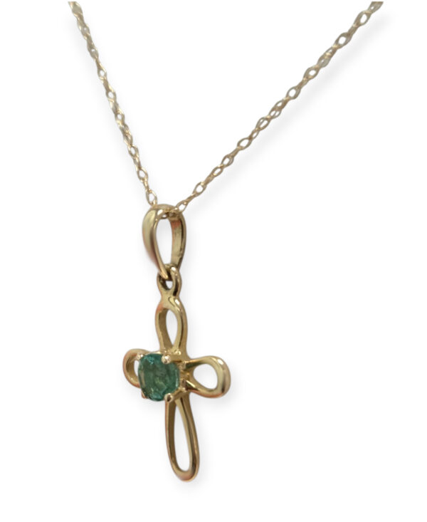 side view of emerald cross necklace