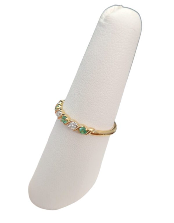 emerald, diamond, and gold ring side view