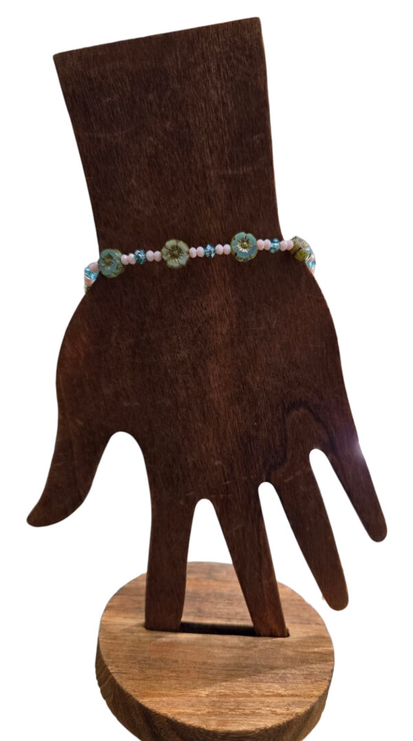 beaded teal flower bracelet on hand form