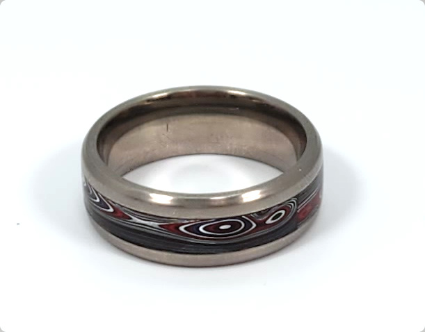 Fordite and titanium band ring in size 10