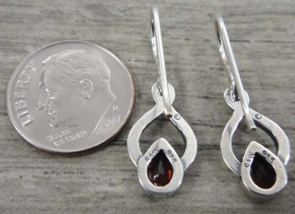 backside of garnet earrings with dime for size comparison