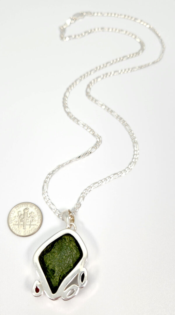 backside of dark gray geode necklace with dime for size comparison