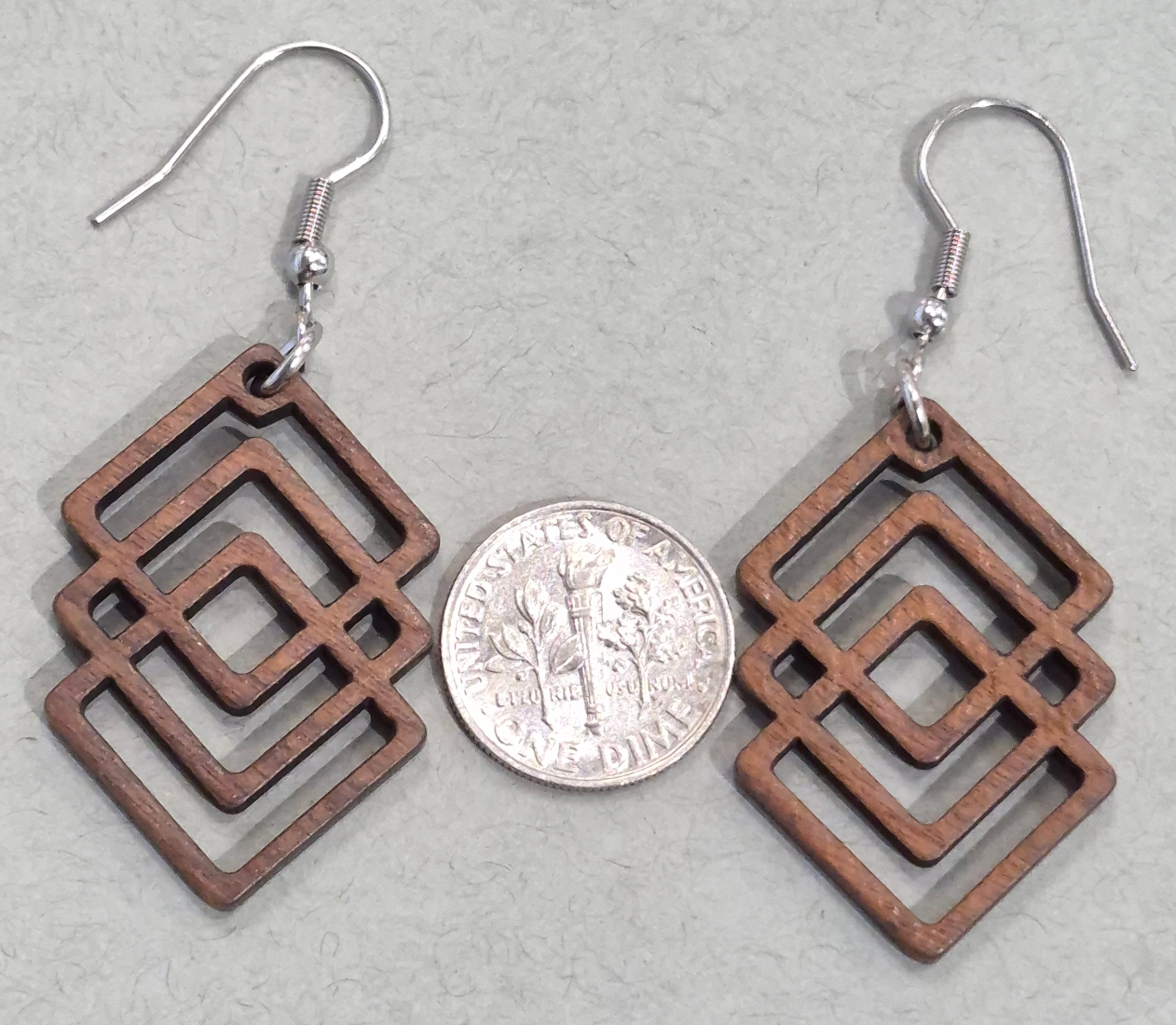 wood geometric earrings with dime for size comparison