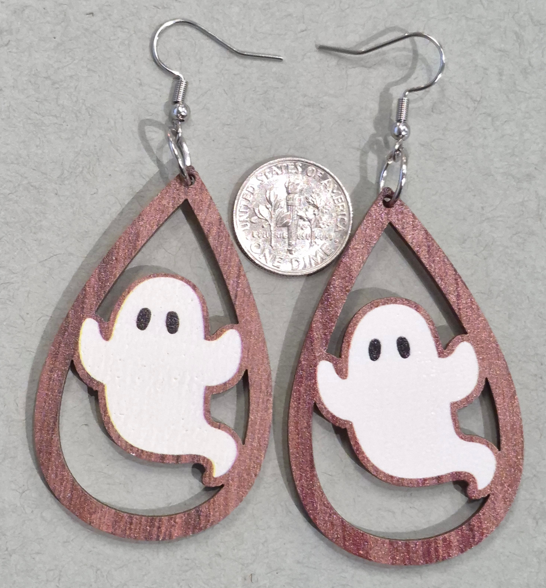 ghost earrings with dime for size comparison
