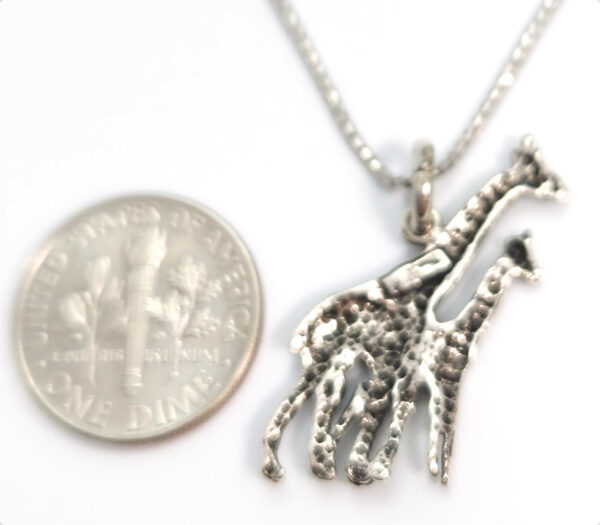 backside of giraffe necklace with dime for size comparison