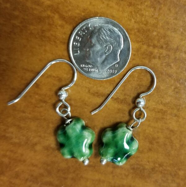 back of green ceramic daisy earrings with dime for scale
