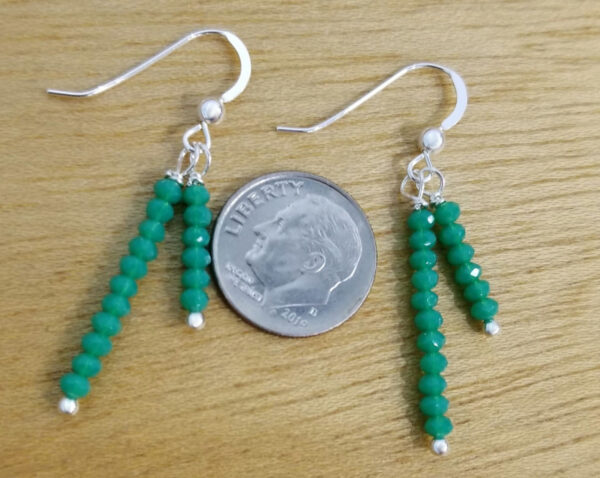 green beaded earrings with dime for scale