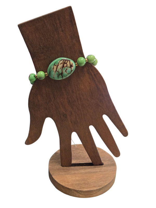 green tagua nut bracelet on hand form
