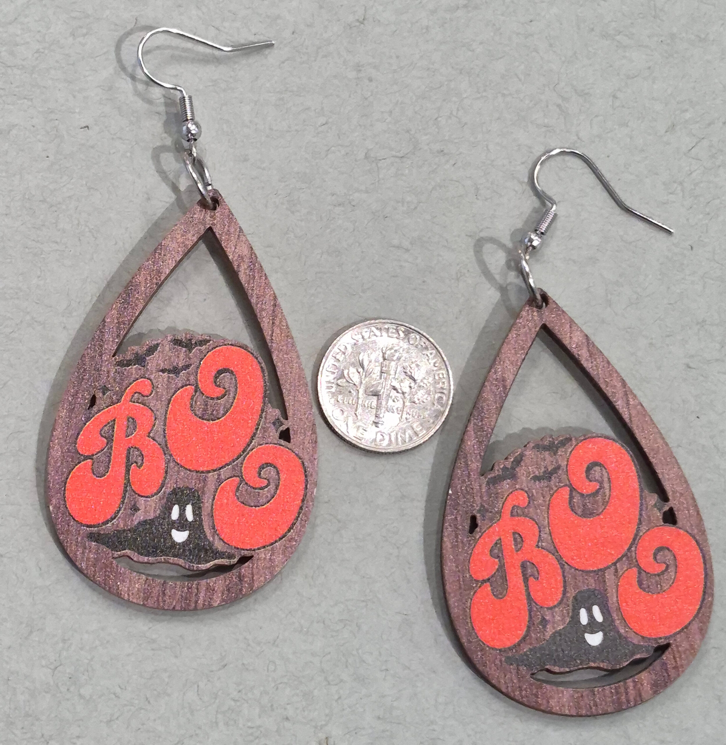 wooden Halloween earrings with dime for size comparison