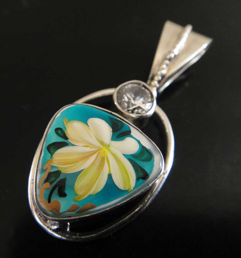 This mother of pearl pendant was hand painted in Russia.