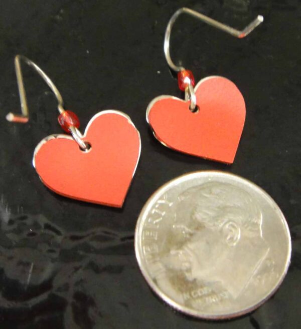 backside of red heart earrings with dime for size comparison