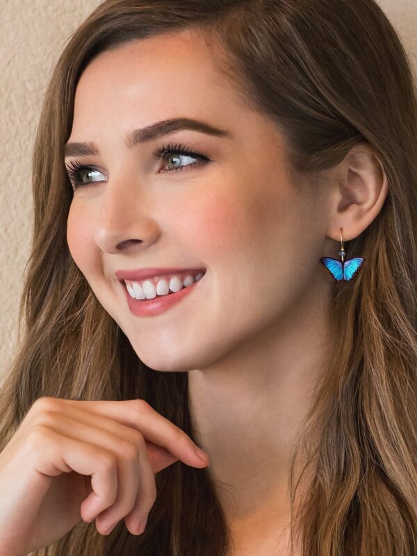 blue butterfly earrings on model