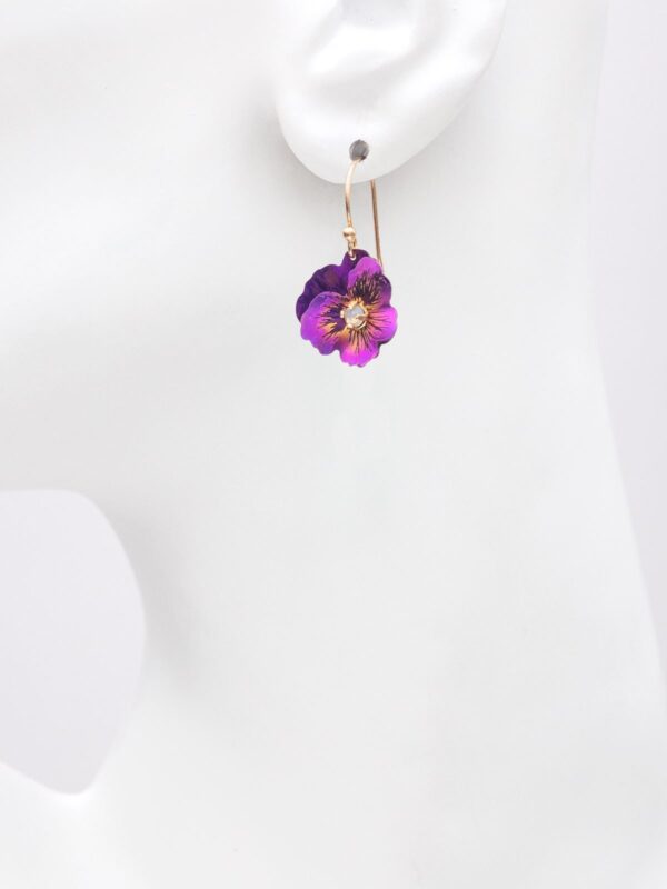fuchsia pansy earrings on model