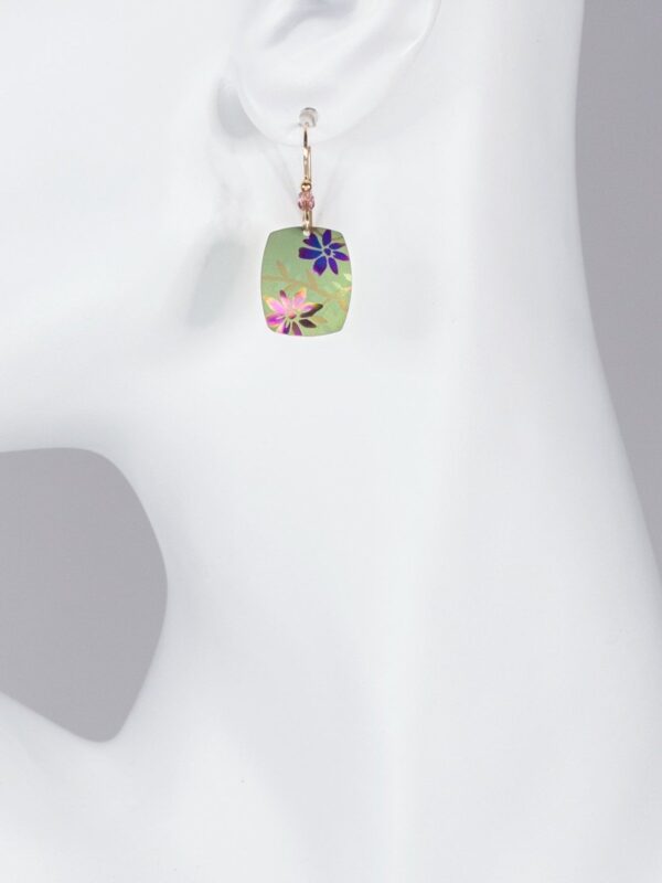 bright green flower meadow earrings on mannequin