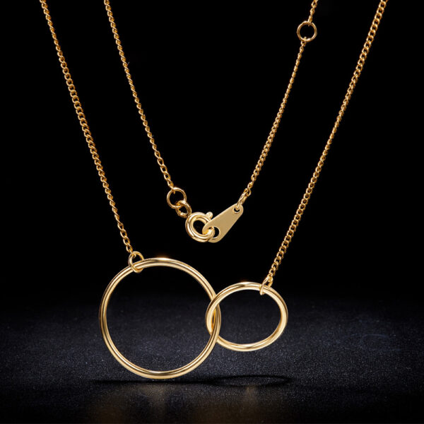 yellow gold-plated sterling silver circle necklace on black background