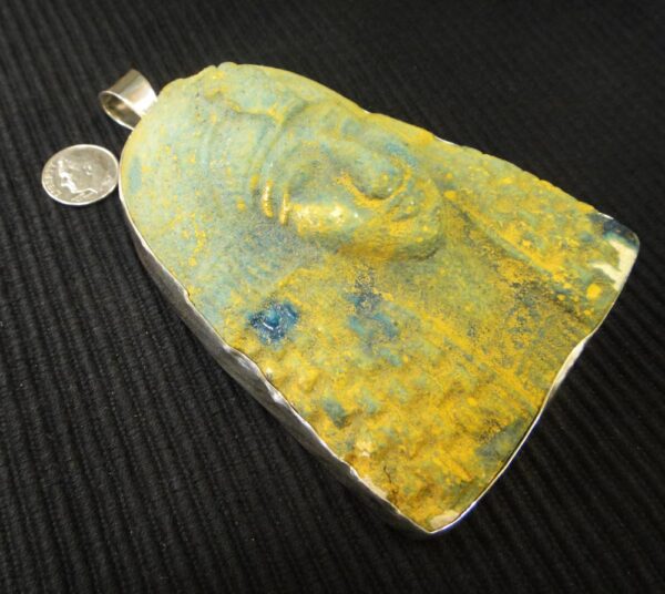 side of large King Tut pendant with dime for size