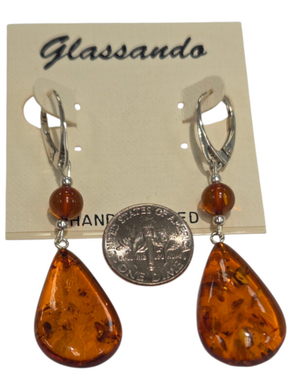 large amber earrings with dime for size comparison