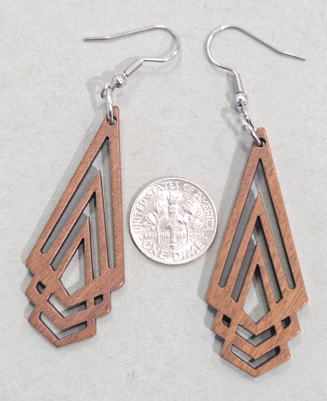 long fan earrings with dime for size comparison
