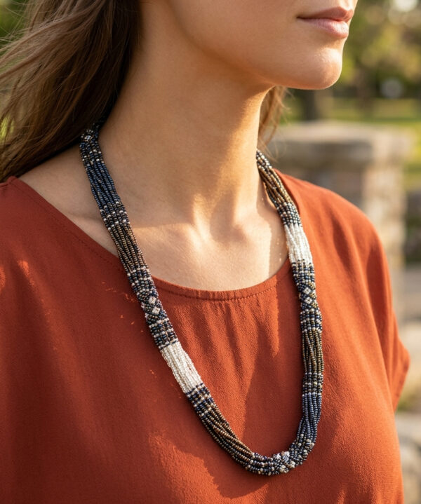 neutral long woven beaded necklace on woman