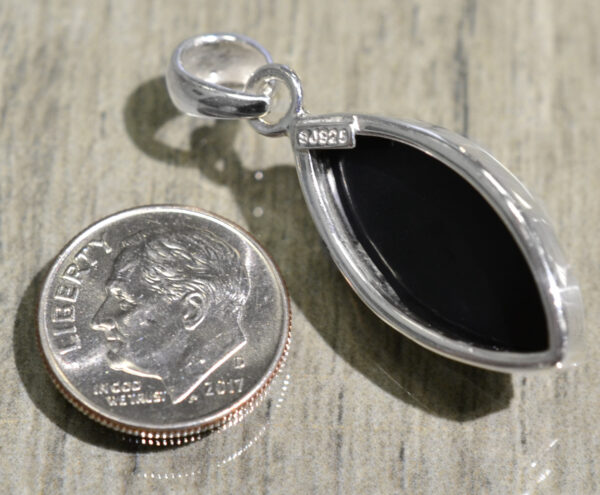 back of marquise shaped black onyx and sterling silver pendant with dime