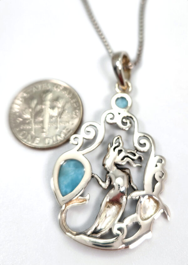 backside of larimar pendant with dime for size comparison