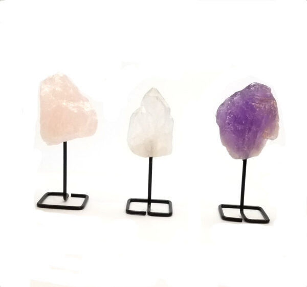 Rose quartz, clear quartz, and amethyst crystals on stands