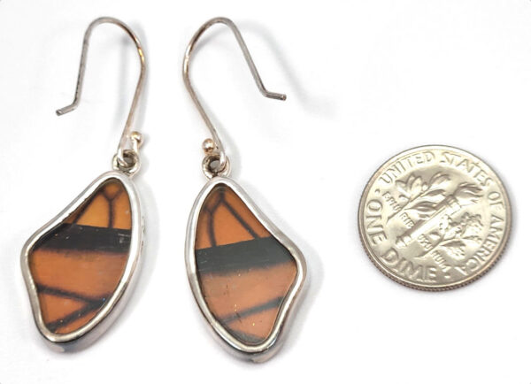 backside of monarch butterfly earrings with dime to show scale
