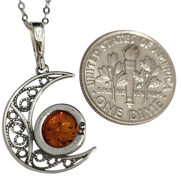 backside of amber moon necklace with dime for size comparison