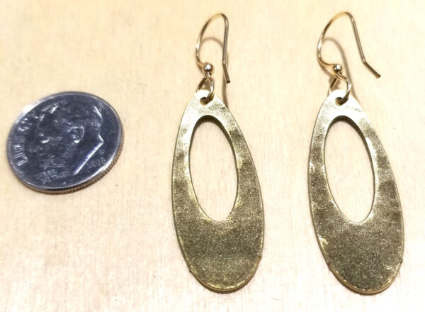 back of olive green earrings with dime for scale
