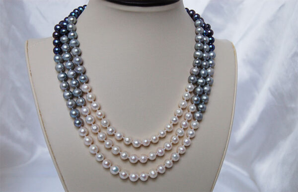 White, silver gray, and dark gray peacock colored three strand pearl necklace