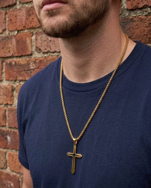 open cross goldtone necklace on man