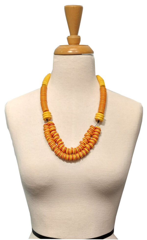 orange and yellow recycled vintage button necklace on mannequin