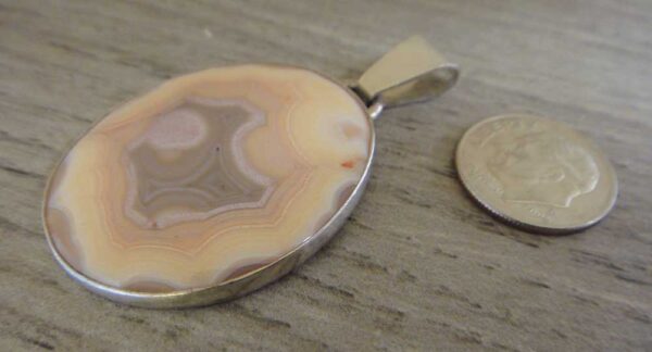 orbicular agate pendant with dime for size