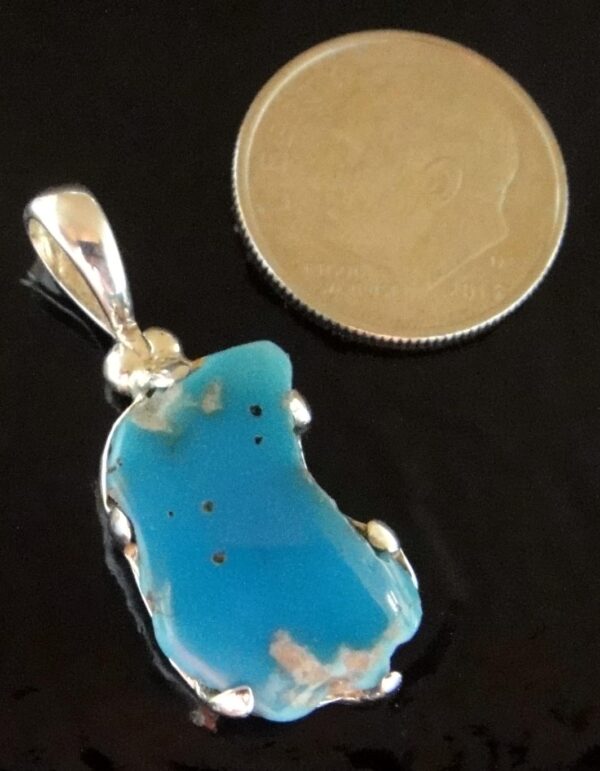This handmade turquoise and sterling silver pendant is a gorgeous shade of bright blue.