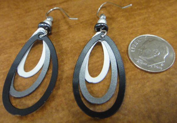 back of drop earrings with dime to show scale