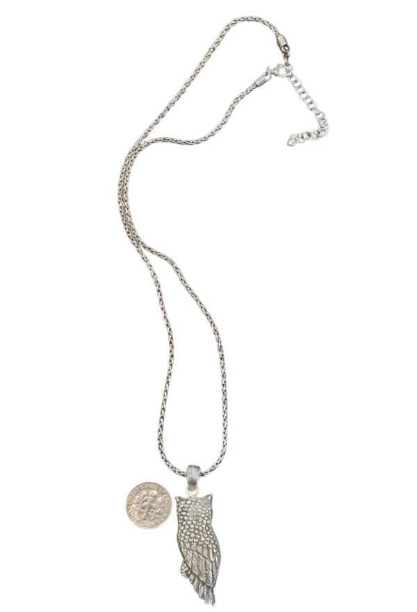 backside of owl necklace with dime for size comparison