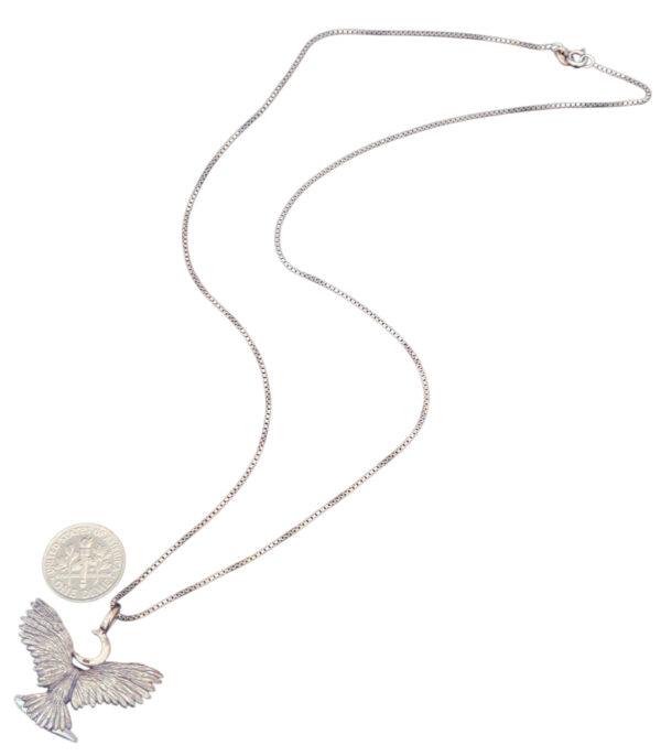 backside of owl necklace with dime for size comparison