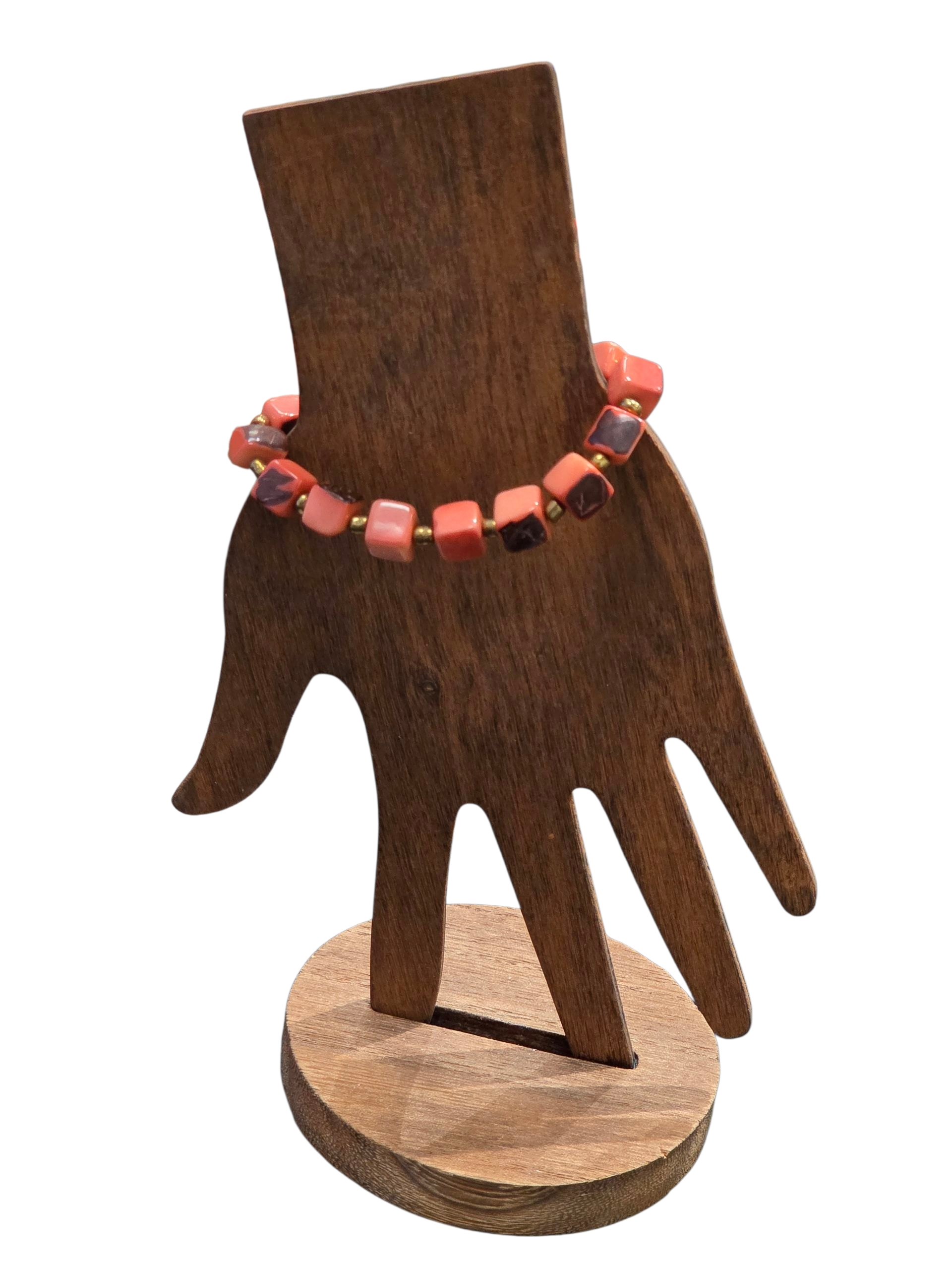 peach color tagua nut cube bracelet on wood form