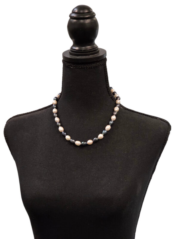 peacock and white pearl necklace on dress form