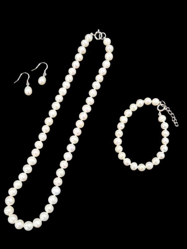 pearl jewelry set including earrings, necklace, and bracelet