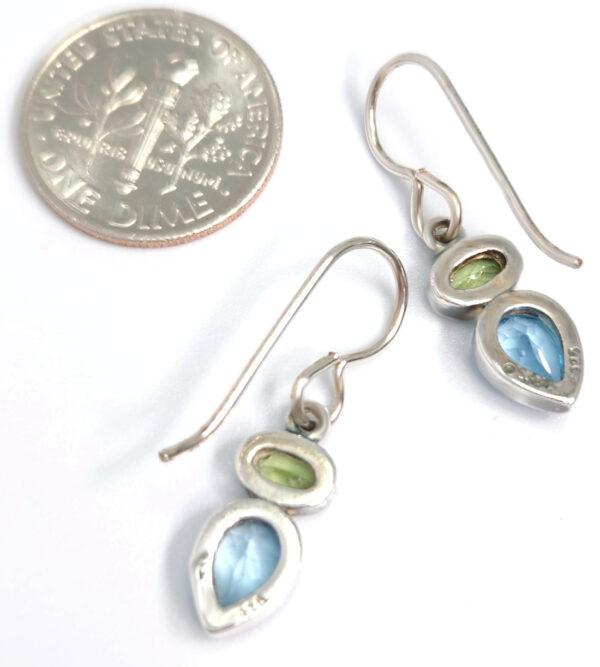 backside of peridot and blue topaz earrings with dime for size comparison