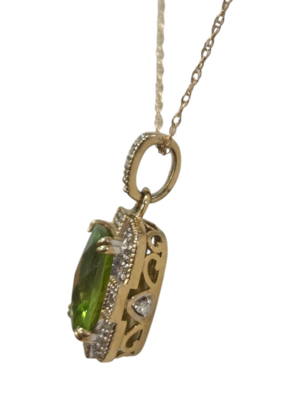 side view of diamond, peridot, and gold necklace
