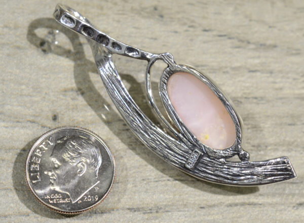 back of handmade pink opal freeform textured pendant with dime