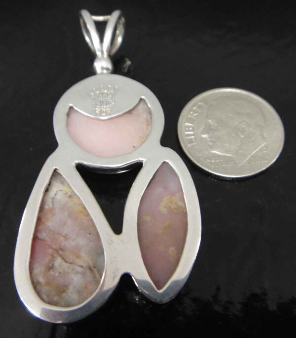 back of pink shell sterling silver pendant with dime for scale