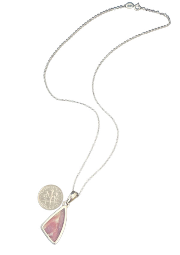 backside of pink tourmaline necklace with dime for size comparison