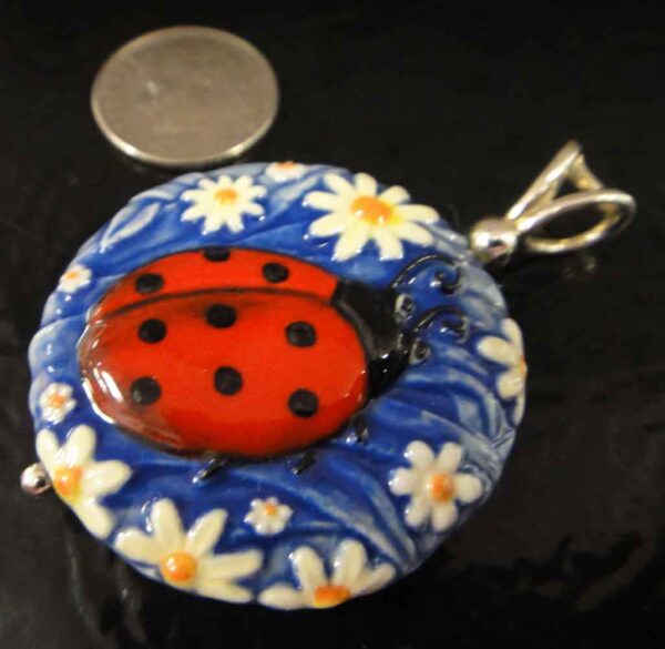 ladybug and daisy pendant with dime for scale